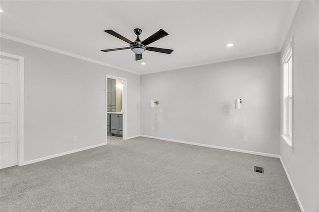 spare room featuring carpet flooring, baseboards, a ceiling fan, and ornamental molding