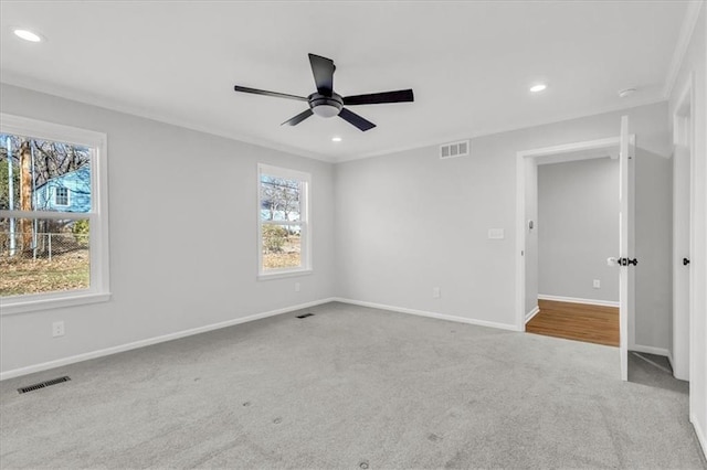 unfurnished room with visible vents, baseboards, a ceiling fan, and carpet floors