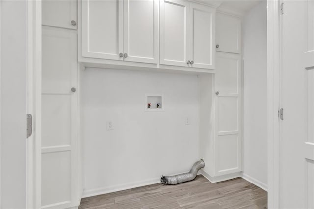 laundry area with cabinet space, hookup for a washing machine, and light wood-type flooring