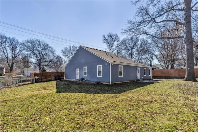 view of side of home featuring a lawn and fence private yard