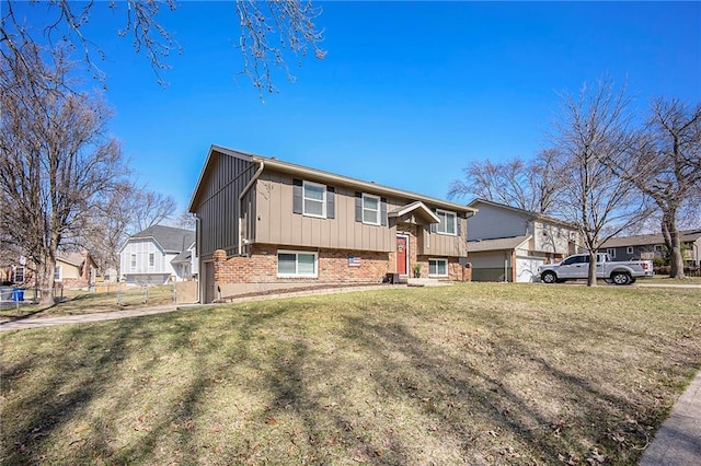 bi-level home featuring board and batten siding, a front lawn, brick siding, and a residential view