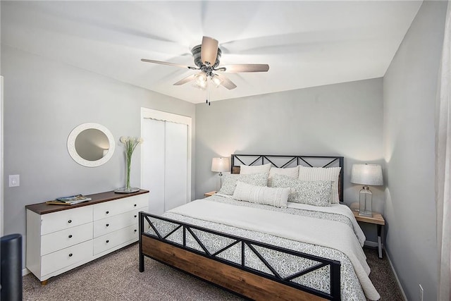 bedroom with a closet, baseboards, carpet, and ceiling fan