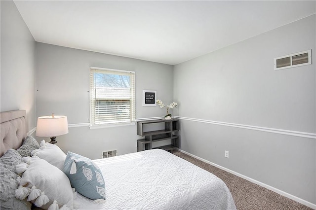 carpeted bedroom with visible vents and baseboards