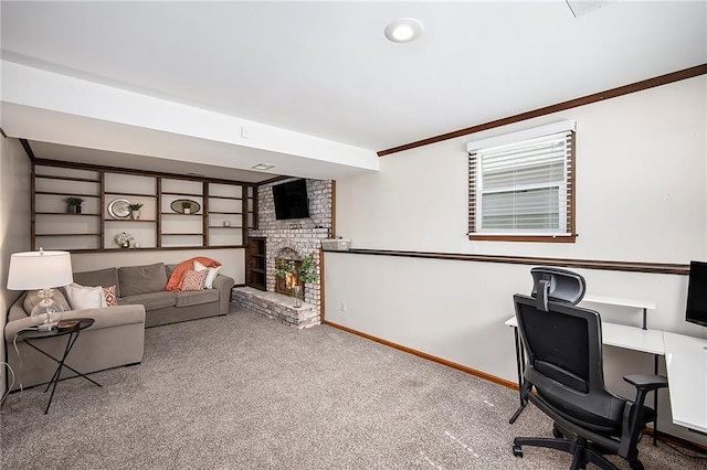 carpeted home office featuring baseboards, a brick fireplace, and ornamental molding