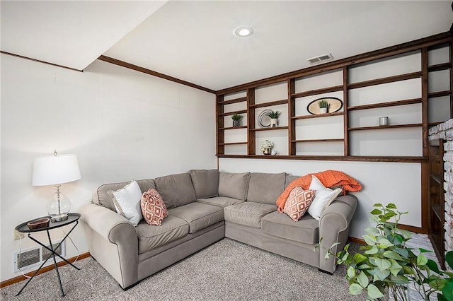 carpeted living area with visible vents, a fireplace, baseboards, and ornamental molding