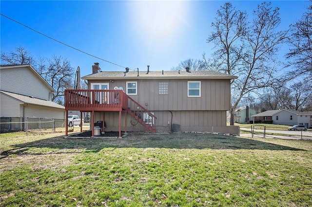 back of house featuring a deck, stairs, fence, a yard, and a chimney