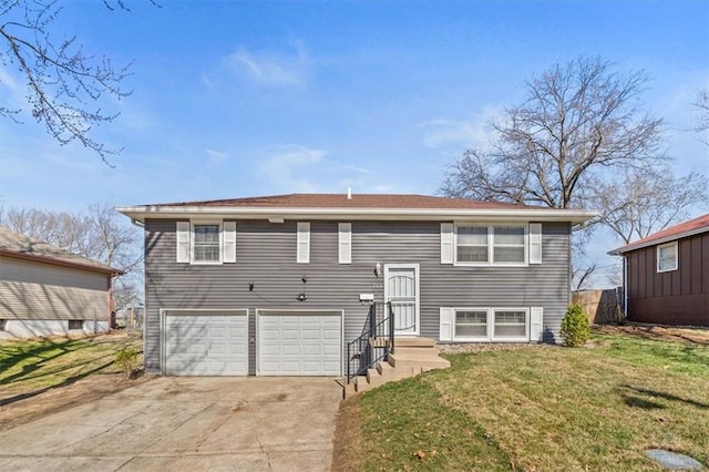 back of property featuring an attached garage, concrete driveway, and a yard