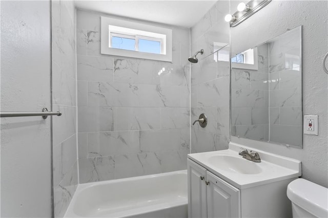 bathroom with toilet, a healthy amount of sunlight, bathing tub / shower combination, and a textured wall