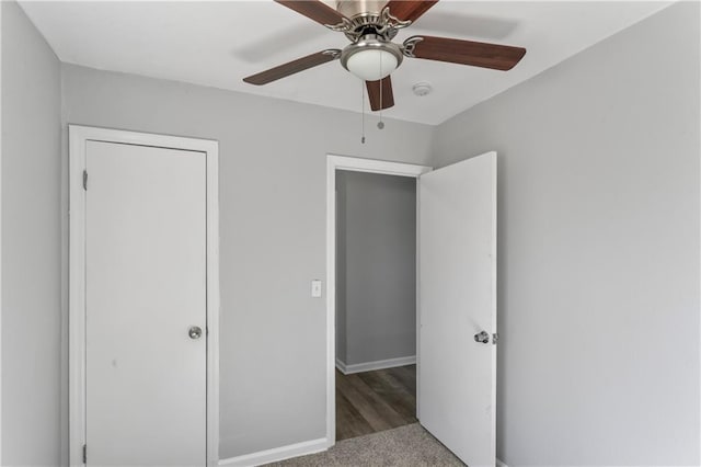 unfurnished bedroom featuring baseboards, carpet, and a ceiling fan