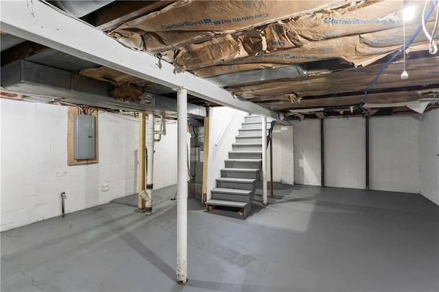 unfinished below grade area with electric panel and stairs