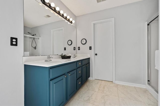 full bathroom featuring double vanity, marble finish floor, a stall shower, and a sink