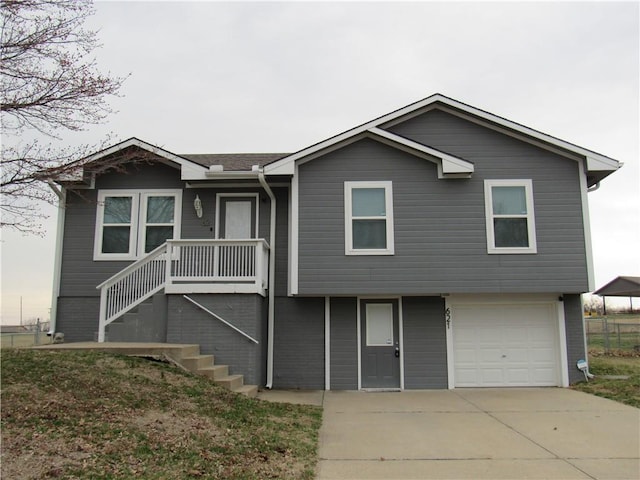 view of front of house with stairs, concrete driveway, and a garage