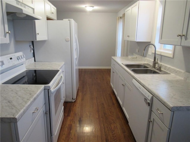 kitchen with white appliances, dark wood-style floors, baseboards, a sink, and under cabinet range hood