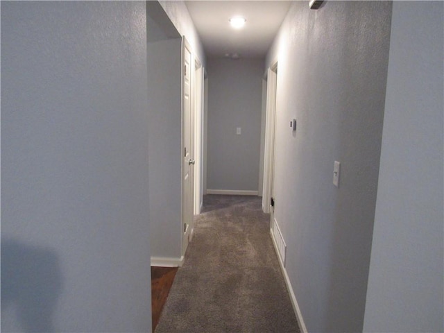 hall with carpet flooring and baseboards