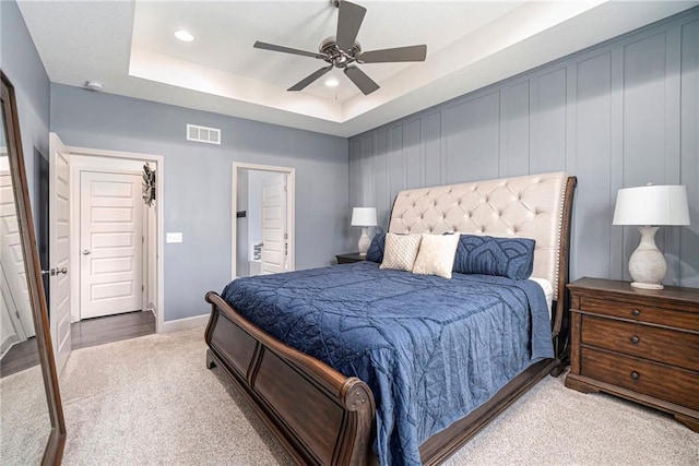 bedroom with visible vents, ceiling fan, a tray ceiling, carpet floors, and recessed lighting