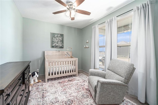 bedroom with baseboards and a ceiling fan