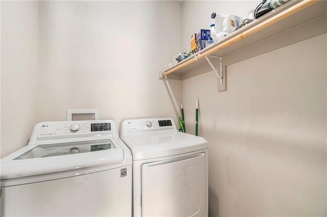 laundry area featuring separate washer and dryer and laundry area