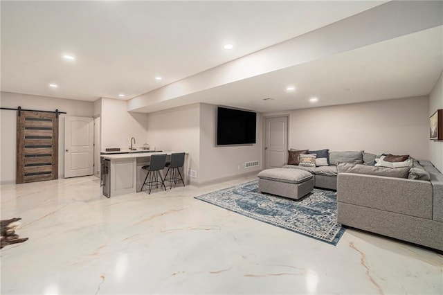 living room with recessed lighting, wet bar, and a barn door