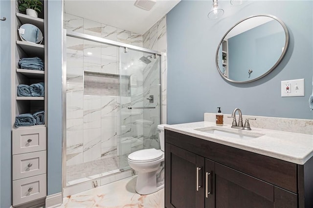 full bathroom featuring vanity, a shower stall, toilet, and marble finish floor