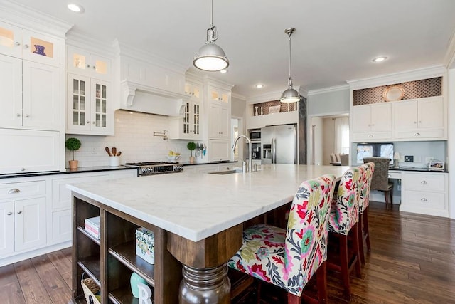 kitchen with a sink, open shelves, ornamental molding, stainless steel appliances, and dark wood-style flooring