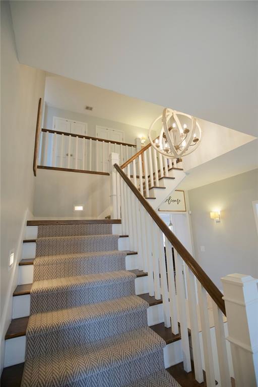 stairway with an inviting chandelier