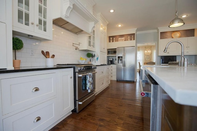 kitchen with dark wood-style floors, ornamental molding, custom range hood, appliances with stainless steel finishes, and tasteful backsplash