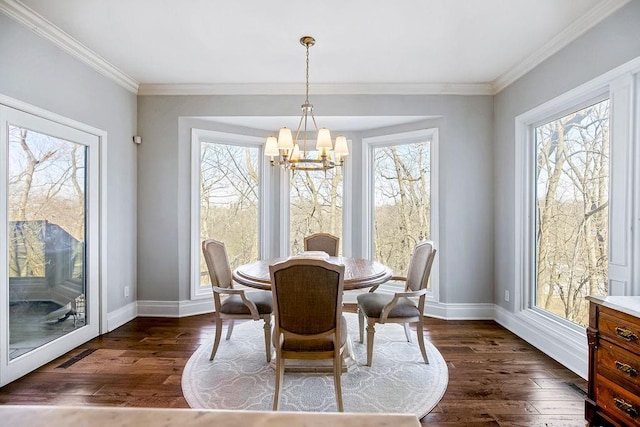 dining space featuring a healthy amount of sunlight, a chandelier, and dark wood-style flooring