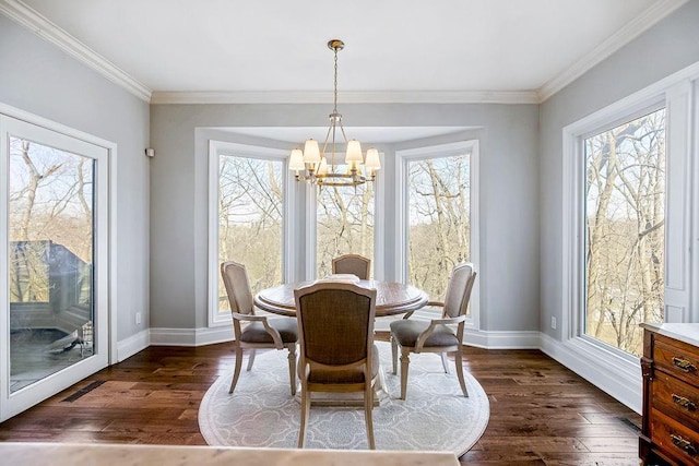 dining space featuring a healthy amount of sunlight, baseboards, and a chandelier