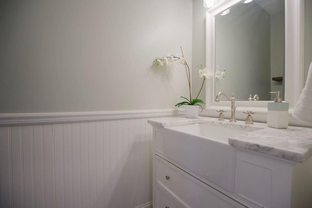 bathroom featuring vanity and a wainscoted wall