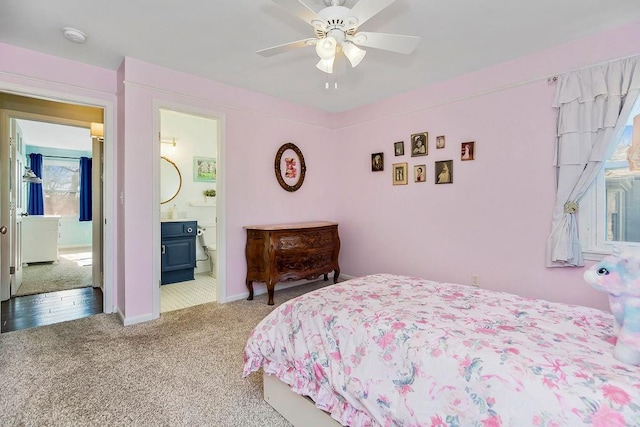 bedroom with baseboards, carpet flooring, a ceiling fan, and ensuite bathroom