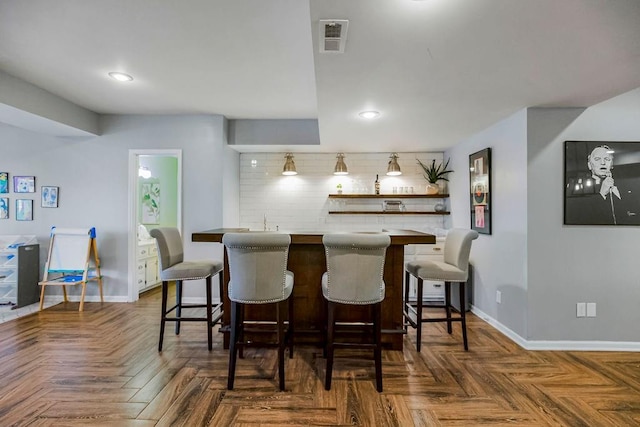 bar featuring indoor wet bar, recessed lighting, baseboards, and visible vents