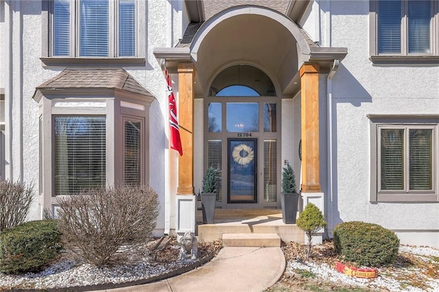 entrance to property with stucco siding