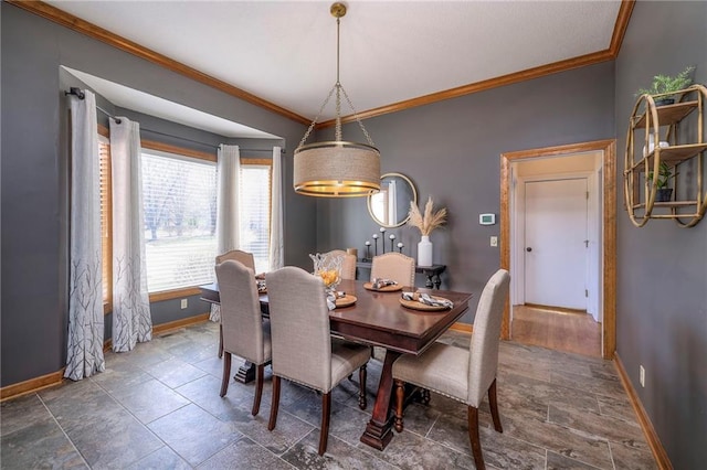 dining space featuring baseboards and crown molding