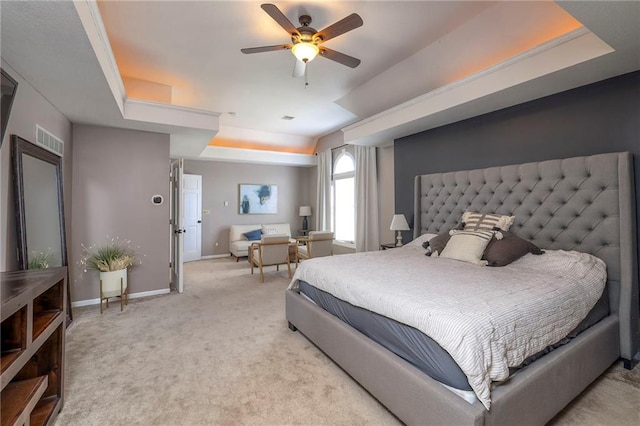 bedroom featuring visible vents, ceiling fan, baseboards, a tray ceiling, and carpet flooring