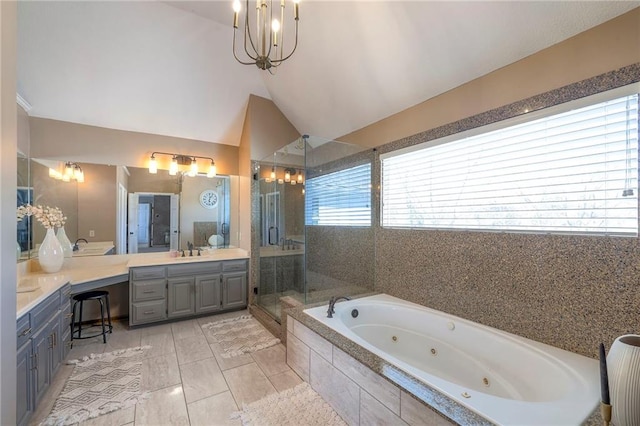 full bath with a shower stall, vaulted ceiling, a notable chandelier, vanity, and a tub with jets