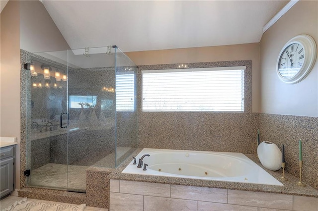 full bathroom featuring a shower stall, lofted ceiling, vanity, and a whirlpool tub