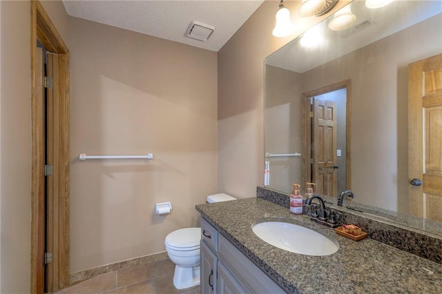 bathroom featuring visible vents, baseboards, toilet, tile patterned floors, and vanity