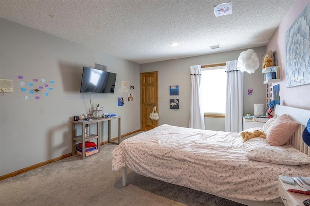 carpeted bedroom featuring baseboards, visible vents, and a textured ceiling