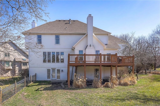 back of house with stairway, a yard, fence, and a chimney