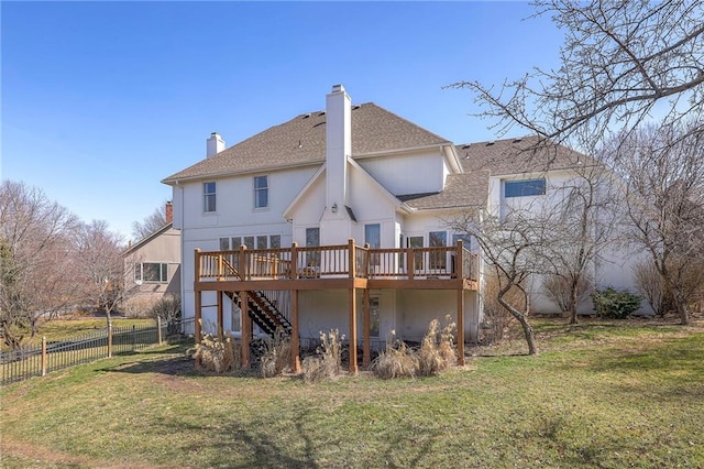 rear view of property featuring a yard, a wooden deck, stairs, and fence