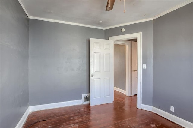 unfurnished room featuring visible vents, ornamental molding, wood finished floors, baseboards, and ceiling fan