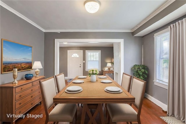 2850 Mersington Ave, Kansas City, MO 64128 - dining space with baseboards, crown molding, and wood finished floors