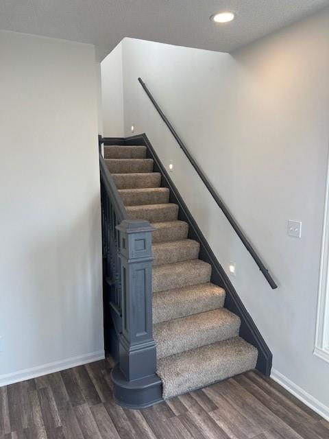 stairs with recessed lighting, baseboards, and wood finished floors