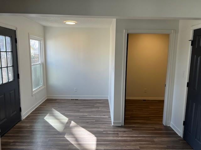 entrance foyer featuring baseboards and wood finished floors