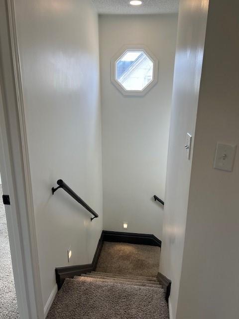 stairway featuring baseboards