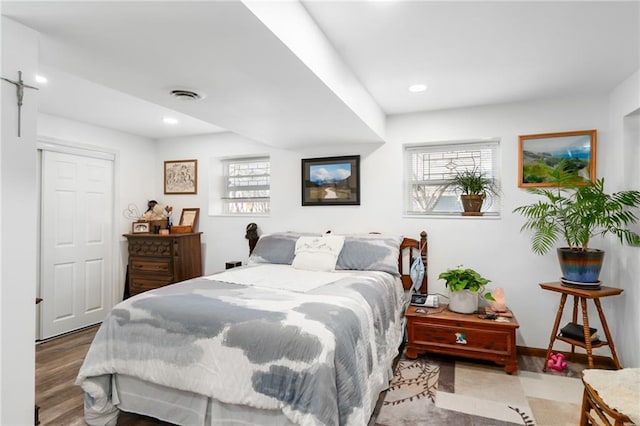 bedroom with visible vents, recessed lighting, baseboards, and wood finished floors