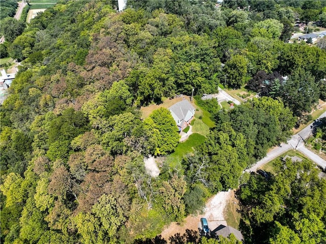 birds eye view of property with a view of trees