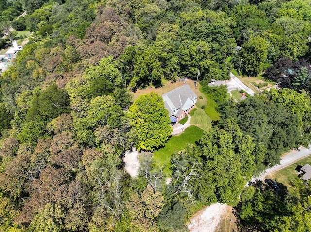 birds eye view of property with a forest view