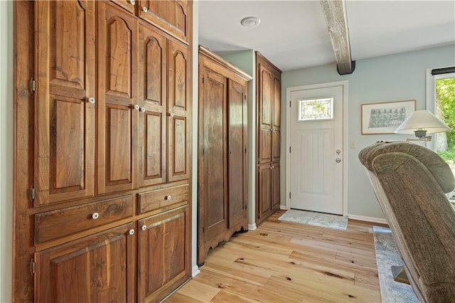 entryway featuring light wood-type flooring and baseboards