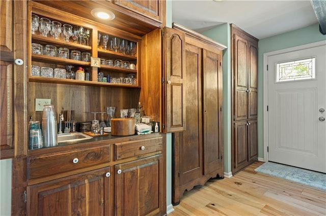 bar featuring light wood-style flooring